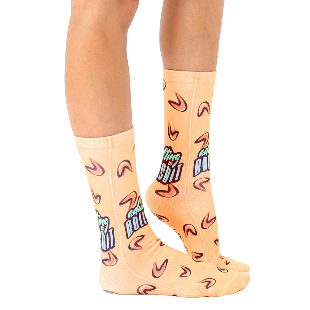 Lifestyle shot of model wearing the 'Adulting is BS' socks, showcasing the fit and style. [lf]