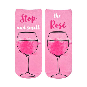pink womens ankle socks with black outline of wine glass and "stop and smell the ros??" text.  