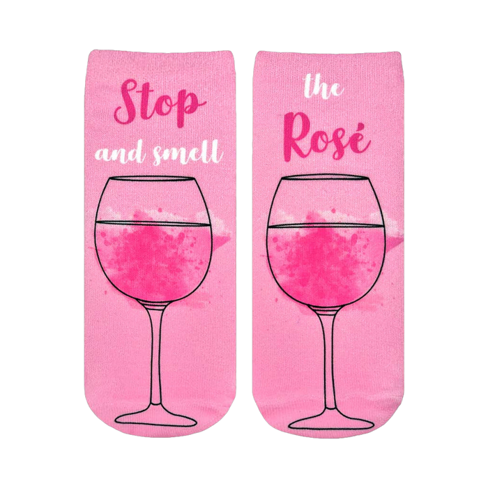 Pair of pink ankle socks featuring a rosé wine glass graphic and the text 'Stop and smell the Rosé'. }}