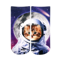 Ankle socks showcasing a ginger kitten in an astronaut's helmet against a cosmic backdrop of a moon and stars. Primarily white, orange, purple, and black.