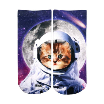 ankle-length purple socks feature an image of a cat astronaut wearing a spacesuit with the american flag patch and a clear bubble helmet.   