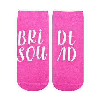 white text on pink socks reads "bride squad"; perfect for a wedding.   