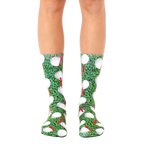 A pair of crew golf socks with a playful design.  The socks are mainly green with white golf balls and red tees. [lf]