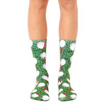 crew length golf socks with a pattern of white golf balls and red tees on a green background. for men and women.  