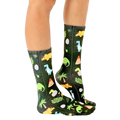 Lifestyle shot of Jurassic Jungle socks on a person's legs, showcasing the sock pattern and fit. [lf]