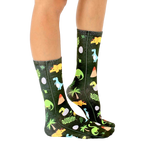Lifestyle shot of Jurassic Jungle socks on a person's legs, showcasing the sock pattern and fit. [lf]