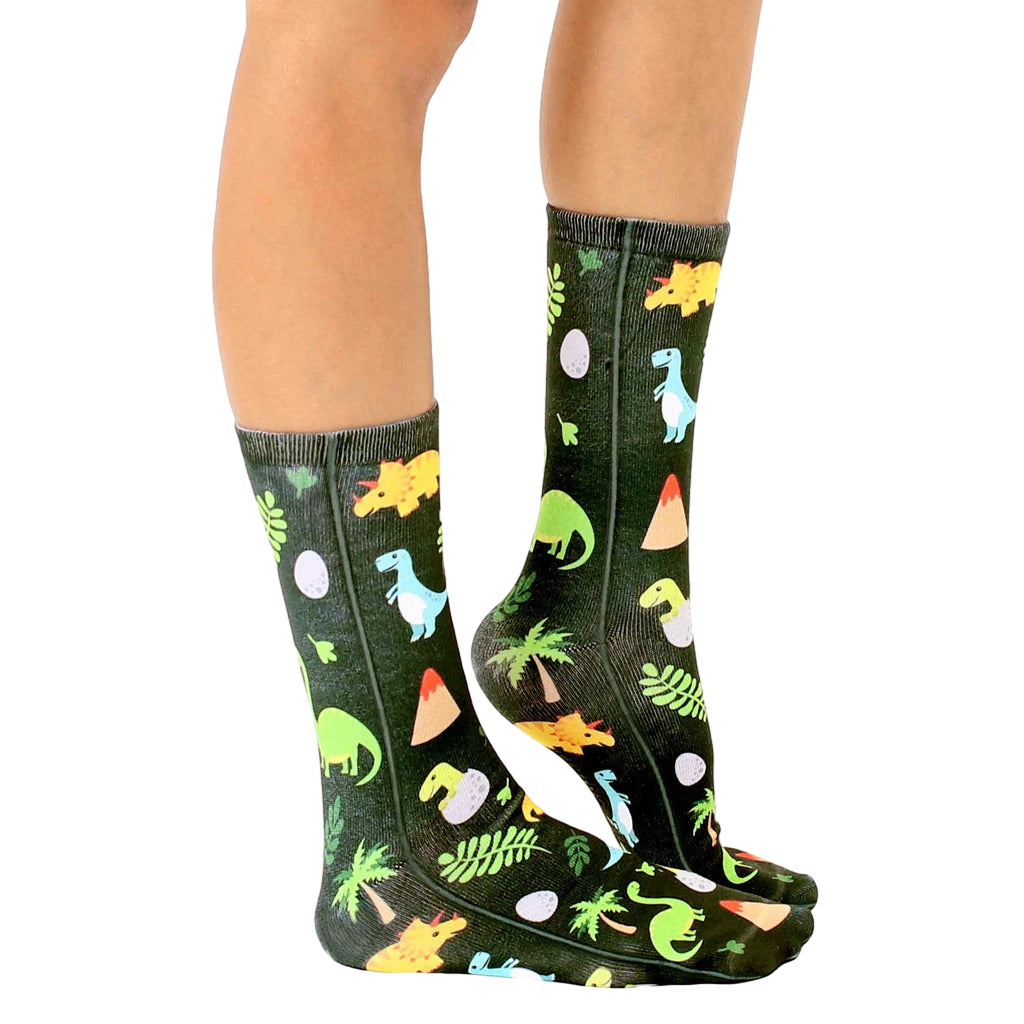 Lifestyle shot of Jurassic Jungle socks on a person's legs, showcasing the sock pattern and fit. [lf]