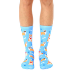 A pair of light blue crew socks featuring a repeating pattern of cute corgis wearing sunglasses, bandanas, and bows, alongside bones and paw prints. [lf]