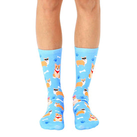 blue crew socks with pattern of cartoon corgis wearing red bandanas and sunglasses on white paw print background.  