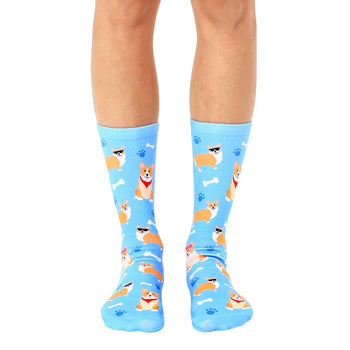 blue crew socks with pattern of cartoon corgis wearing red bandanas and sunglasses on white paw print background.  