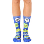 A pair of blue crew socks with a comic book design featuring yellow and green speech bubbles that say 'Pow!', 'Bam!', and 'Wow!' [lf]
