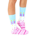 Lifestyle photo showcasing the Birthday Cake socks on a person's feet. [lf]