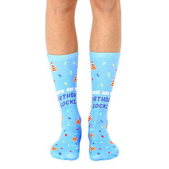  blue crew socks featuring a pattern of multicolor party hats and confetti; for men and women.  