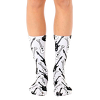 A pair of white crew socks with a repeating pattern of black and white electric and acoustic guitars. [lf]