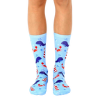 A pair of light blue crew socks with a whimsical design featuring whales, lighthouses, and crabs. [lf]