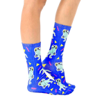 Lifestyle shot showing the Partysaurus socks on a person's feet, from the side [lf]