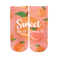 Pair of pink ankle socks with a peach pattern.  The socks say 'Sweet as a peach' in white script. Peaches are illustrated with green leaves.