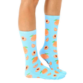 Lifestyle shot: Person wearing light blue peach socks with the socks slightly angled. [lf]