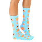 Lifestyle shot: Person wearing light blue peach socks with the socks slightly angled. [lf]