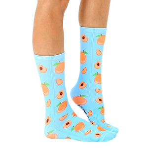 A pair of blue socks with a pattern of cartoon peaches.