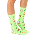 Lifestyle shot of lime green Woodland Animal socks on a person's legs, showcasing the socks in a natural setting. [lf]