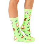 Lifestyle shot of lime green Woodland Animal socks on a person's legs, showcasing the socks in a natural setting. [lf]