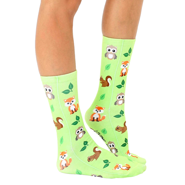 Lifestyle shot of lime green Woodland Animal socks on a person's legs, showcasing the socks in a natural setting. [lf]