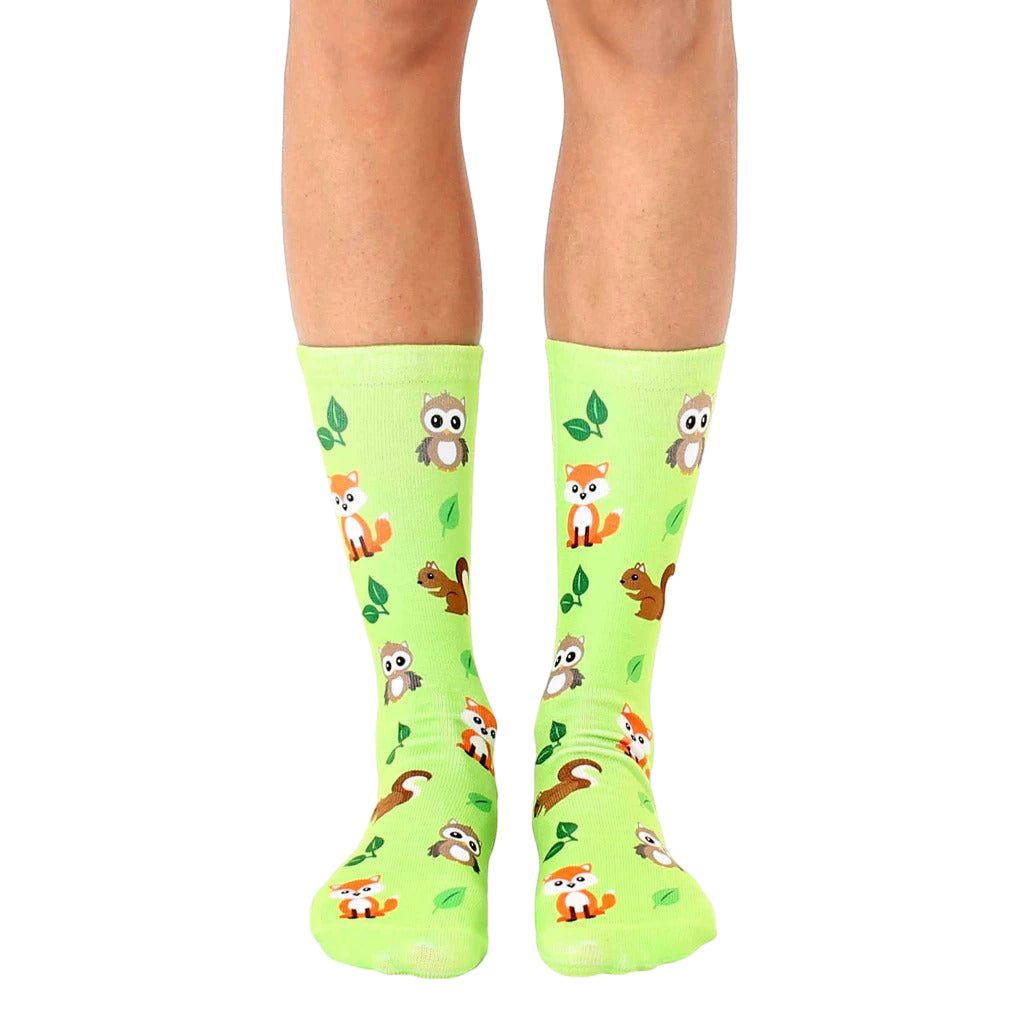 Lime green crew socks featuring adorable foxes, owls, and squirrels, alongside small green leaves. [lf]
