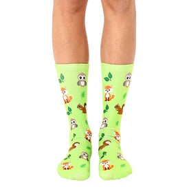   light green crew socks with a pattern of foxes, owls, raccoons, squirrels, and green leaves. perfect for men and women who love the forest.  