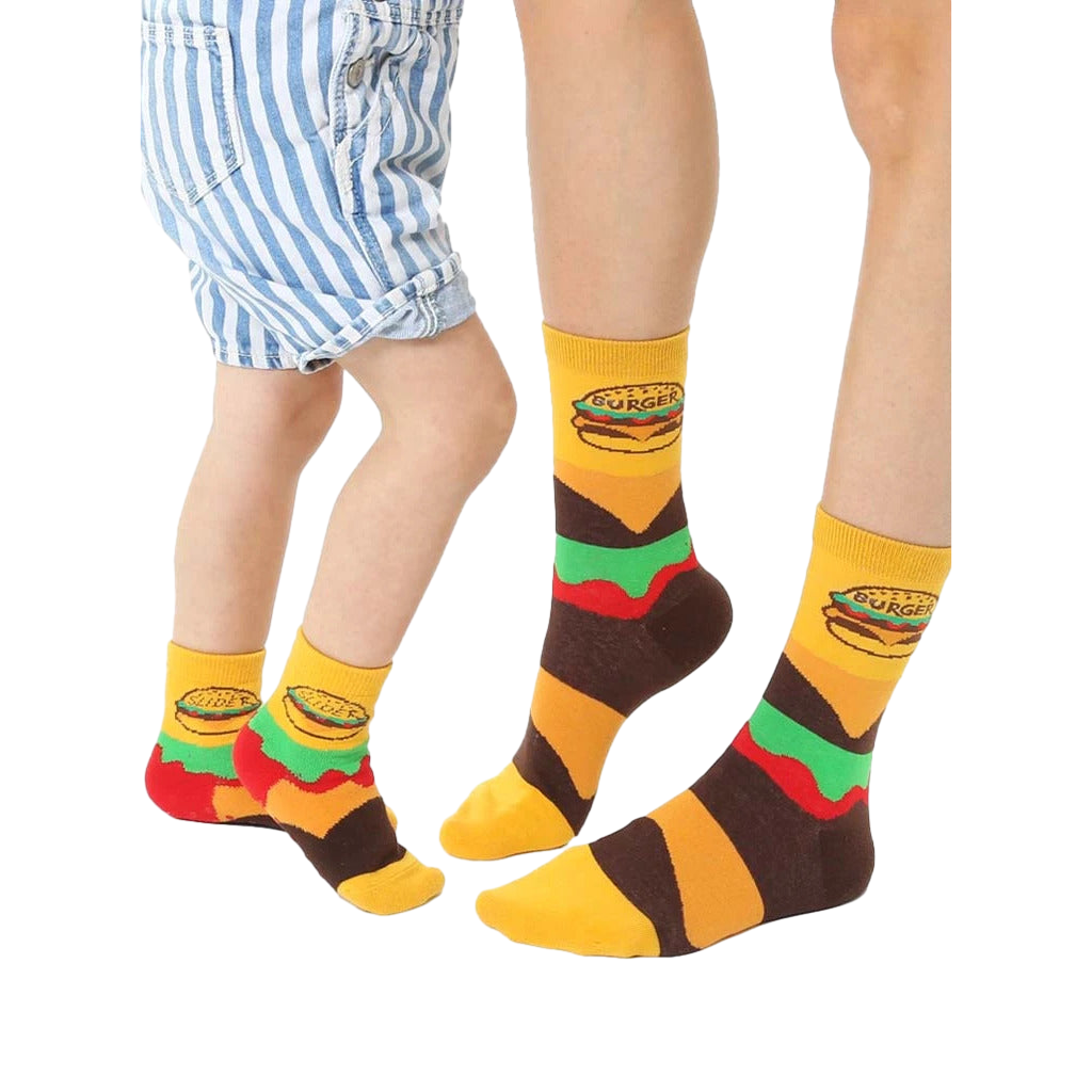 Adult and child crew socks in yellow, brown, and green.  Burger graphics and stripes decorate these fun, matching food socks. [lf]