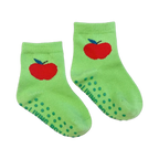 Close-up of a pair of lime green baby socks with a red apple and non-slip grips.