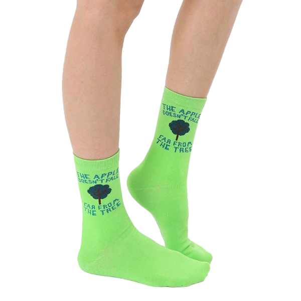 A pair of women's lime green crew socks with the phrase 'The apple doesn't fall far from the tree' and a small tree graphic. [lf]