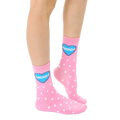 Close-up of adult-sized pink polka dot socks with a blue heart that says 'Friends'. [lf]