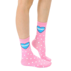 Close-up of adult-sized pink polka dot socks with a blue heart that says 'Friends'. [lf]
