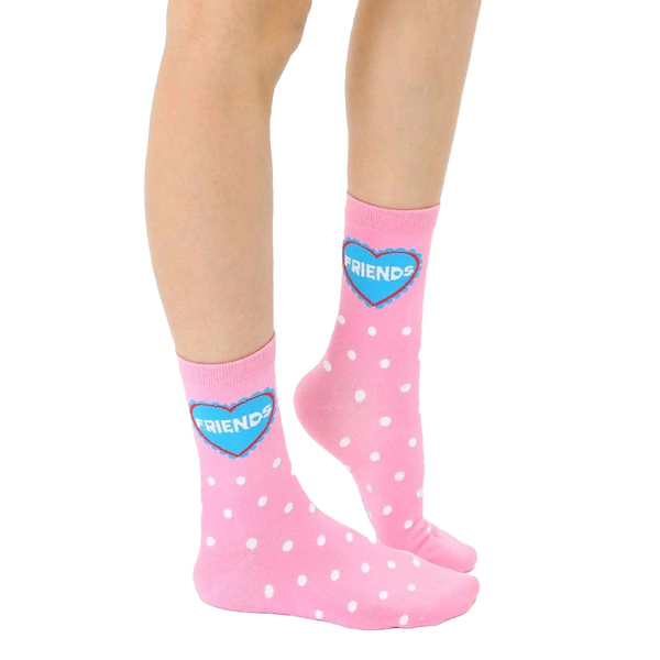 Close-up of adult-sized pink polka dot socks with a blue heart that says 'Friends'. [lf]