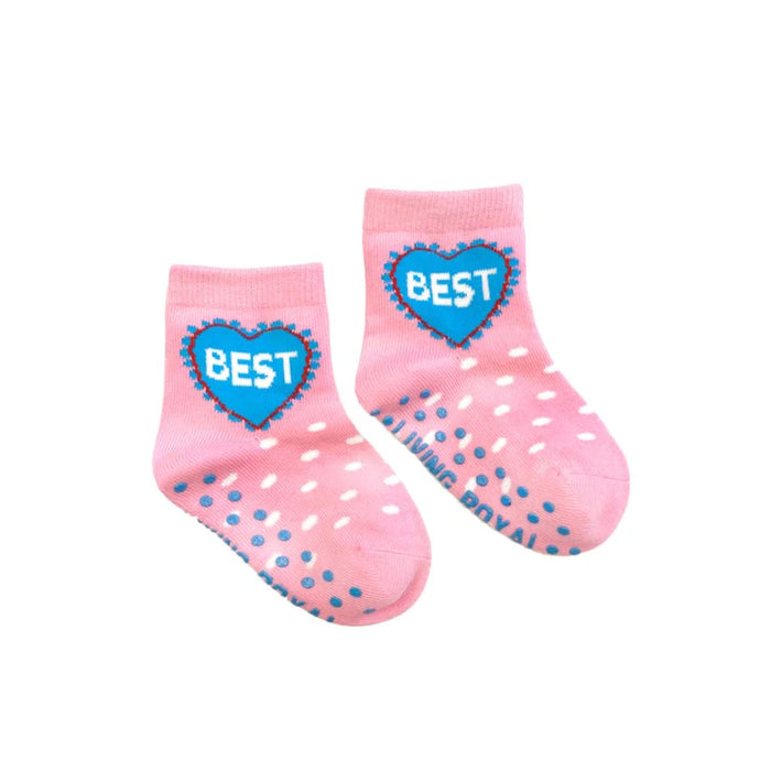 A pair of pink baby socks with blue polka dots and the word 