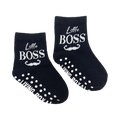 Flat lay product shot showing a pair of 'Little Boss' baby socks with grippers on the soles.