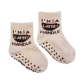 A pair of mini 'Coffee Me And Mini' socks; shows the grippers on the bottom.