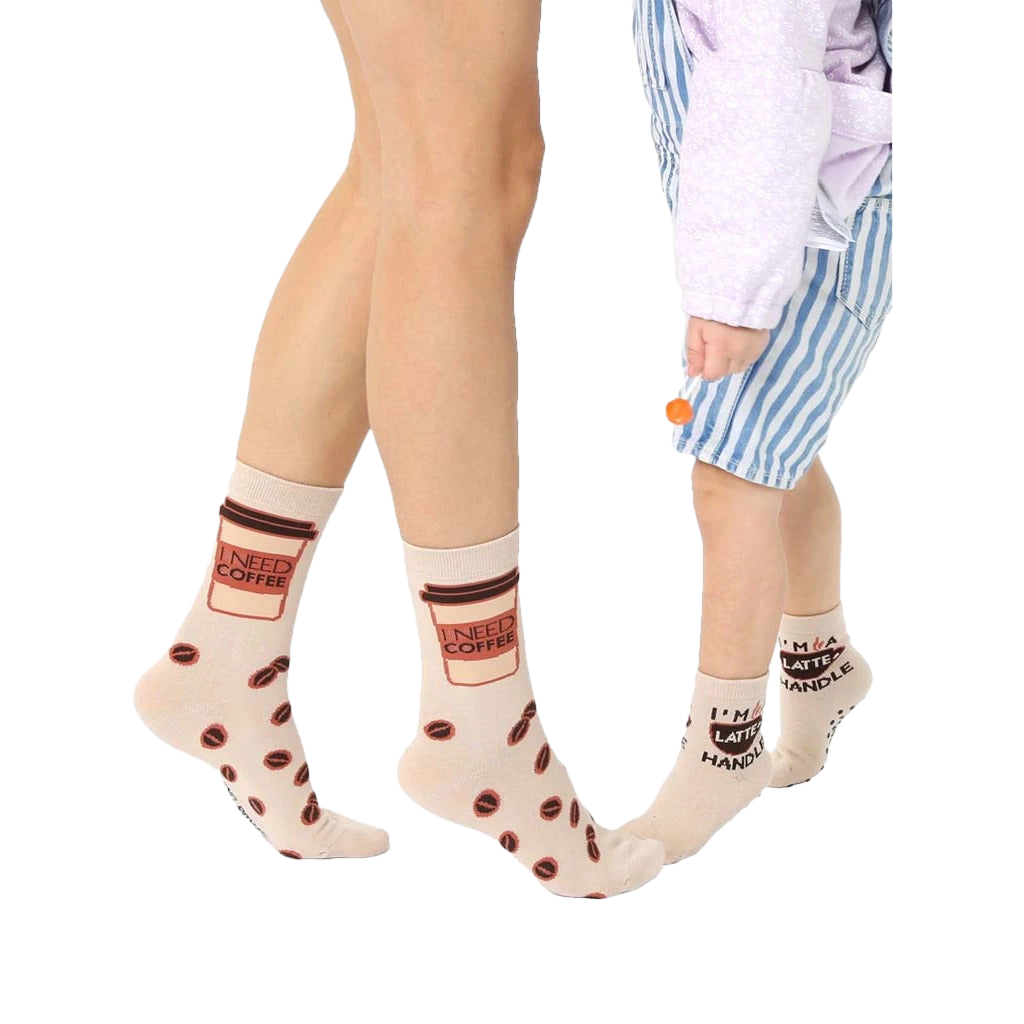 Beige crew socks with coffee cup and bean designs. Adult socks say "I need coffee", mini socks say "I'm a latte handle". [lf]