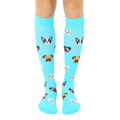 Pair of light blue knee-high socks with a pattern of cute cartoon dog faces. The dogs are various breeds and colors. [lf]