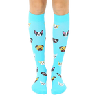 Pair of light blue knee-high socks with a pattern of cute cartoon dog faces. The dogs are various breeds and colors. [lf]
