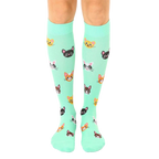 Pair of mint green knee-high socks with a pattern of cute, colorful cat faces. [lf]