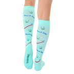 Rear view of mint green knee-high socks showcasing the 'Living Royal' branding on the heel. [lf]