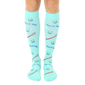 Pair of mint green knee-high socks featuring smiling faces, toothbrushes, and the text 'Smile On!' [lf]