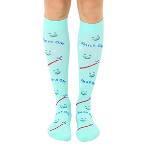  mint green knee-high socks with cartoonish smiling teeth, toothbrush, and 
