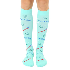  mint green knee-high socks with cartoonish smiling teeth, toothbrush, and "smile on!" lettering. for men and women dentists, hygienists, or orthodontics enthusiasts.  