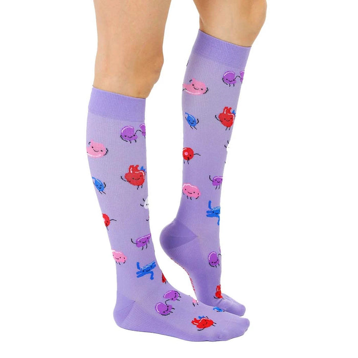 A pair of purple knee-high socks with cartoon organs on them. The organs include a heart, a brain, a liver, a kidney, a pancreas, and a stomach.