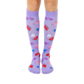 Pair of lavender knee-high socks with a fun pattern of cartoon blood cells in pink, red, and blue.