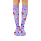 Pair of lavender knee-high socks with a fun pattern of cartoon blood cells in pink, red, and blue.