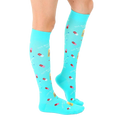 Lifestyle shot of a person wearing the turquoise "Best Medicine" knee-high socks. [lf]